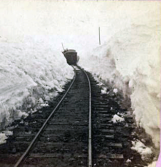 Reaching for the Out of Reach 19: A train runs between large banks of snow on the F&P, Wisconsin, circa 1890. [ more from this project (nypl permalink) ]