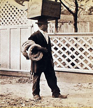Reaching for the Out of Reach 21: A street vendor balances a box on his head, South Carolina, circa 1875. [ more from this project (nypl permalink) ]