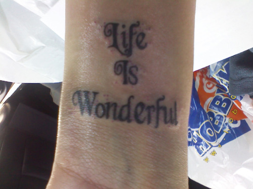  is my first tattoo. 'Life Is Wonderful' is a song title by Jason Mraz.