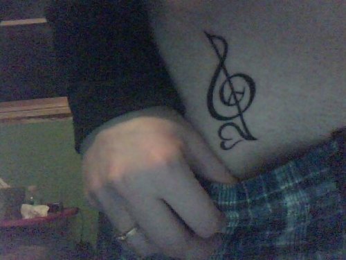 First tattoo symbolizing Peace, Love, and Harmony