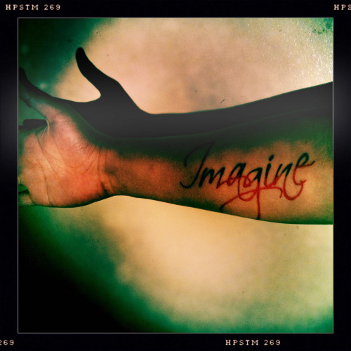My first tattoo It says Imagine done in red ink with black accents