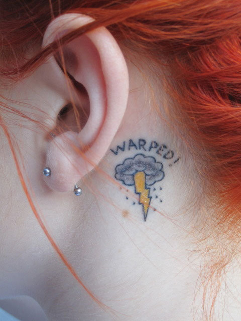 tattoo behind her left ear