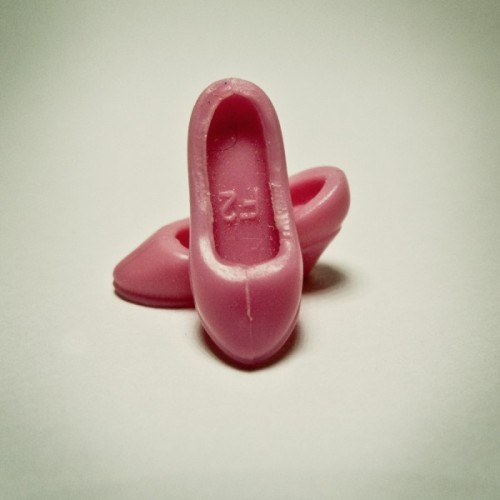 Photographs of tiny plastic shoes for dolls | automatic lifestyle dispenser