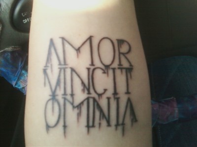 amor vincit omnia meaning. It says “Amor Vincit Omnia,”