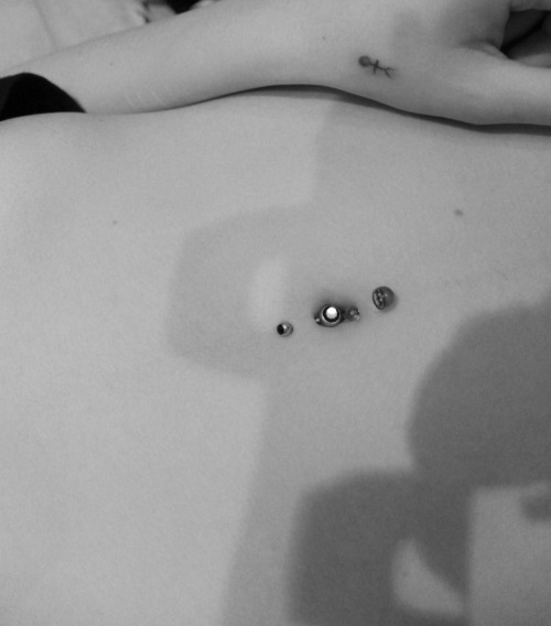 Piercings Shown: Top & bottom belly button (The stickman on the hand is a 