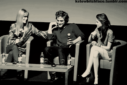 Kristen secretly touching Rob’s elbow. eee (I love how she’s pretending to stretch after touching his elbow.)