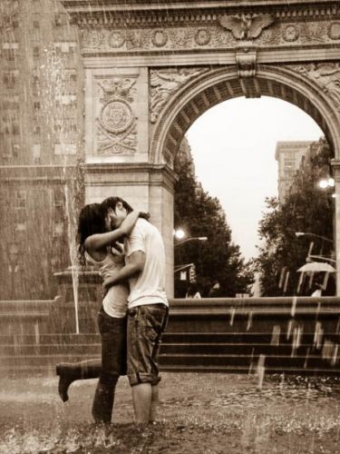 young couple kissing in the rain. oh, kissing in the rain is