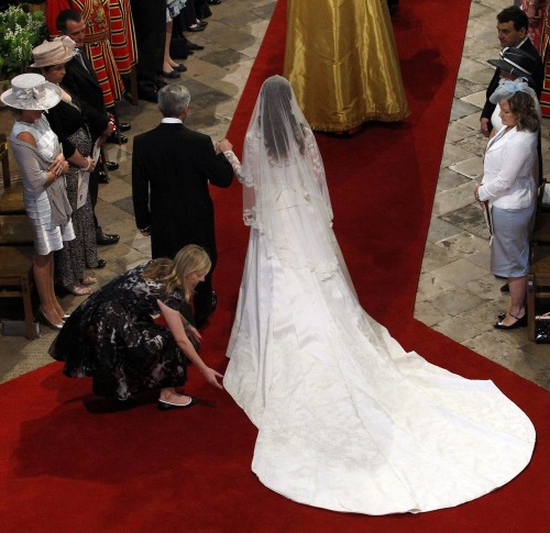 
Alexander McQueen gown designer Sarah Burton adjusts Kate&#8217;s dress as she arrives with her father. (Getty Images)
Kate&#8217;s royal wedding gown revealed
