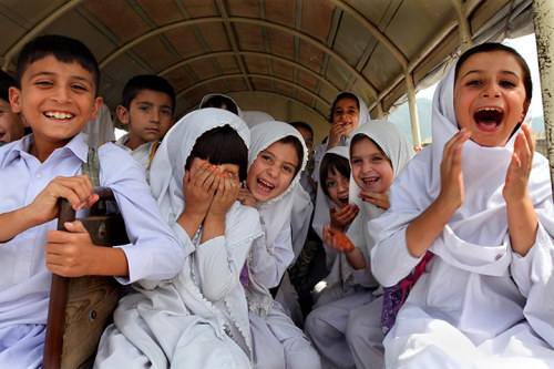 Schoolchildren in their bus near Mingora. A semblance of normality has returned to the southern part of the Swat valley which suffered relatively minor flood damage