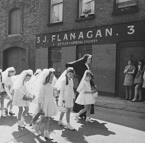A young nun walking Holy Communion girls through the Manor Street area of 