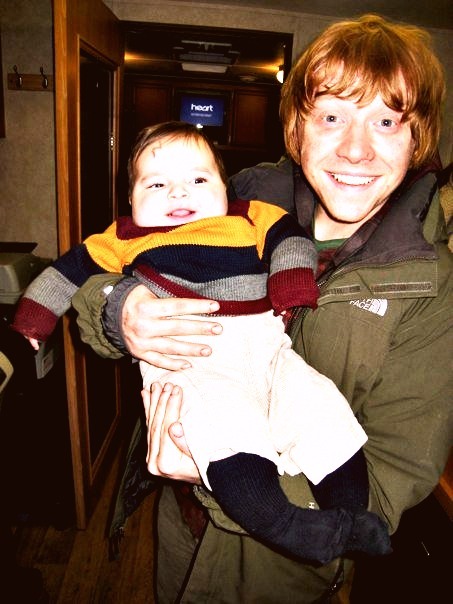 Rupert holding baby Harry Potter